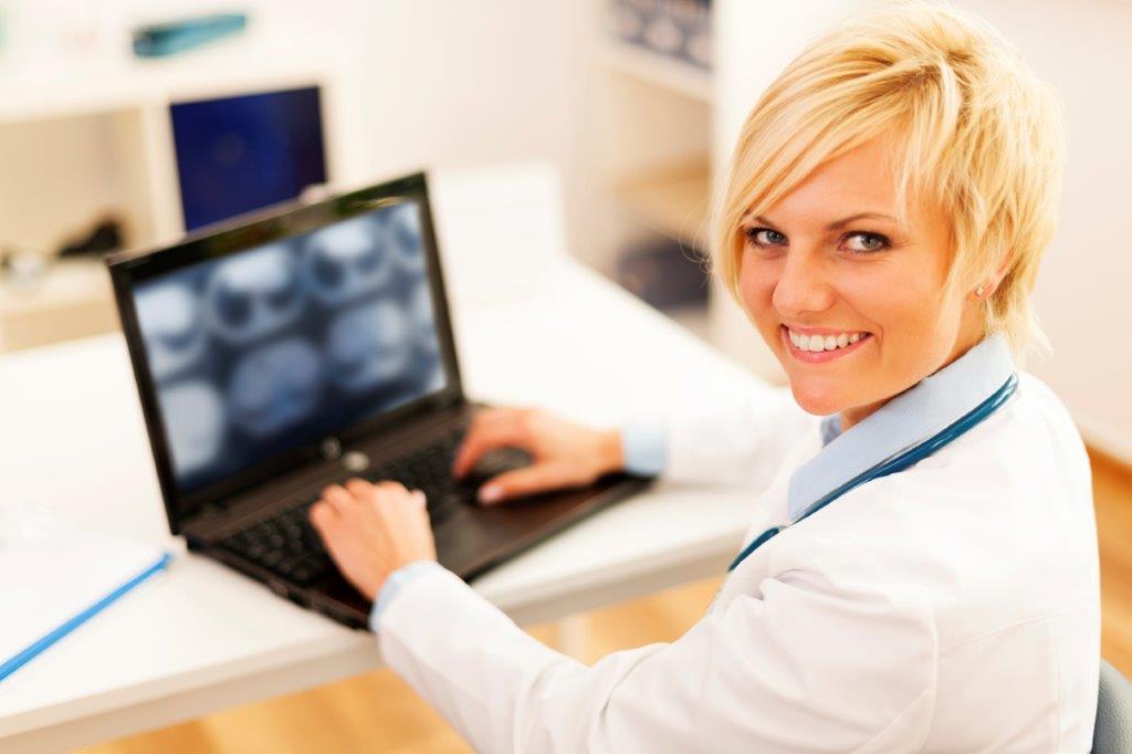 Doctor analyzing image on notebook computer